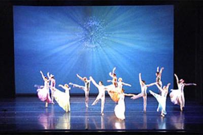 Dancers in front of large screen with digital projection Dancers in front of large screen with digital projection