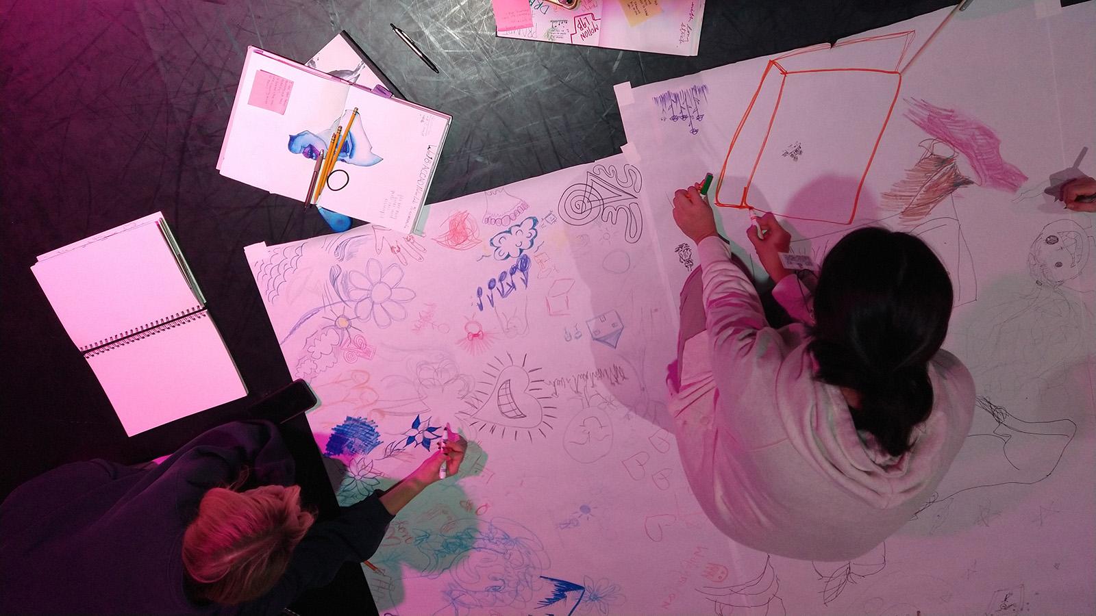 An overhead shot of a student working on a drawing