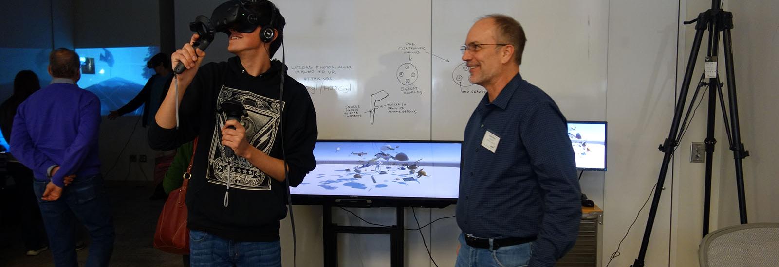 Visitor interacting with a VR headset at ACCAD's 2017 open house