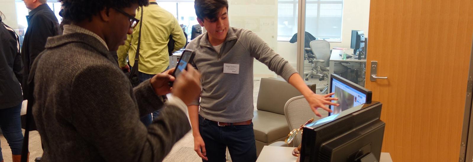 A student showing their work to visitors at the ACCAD 2017 open house